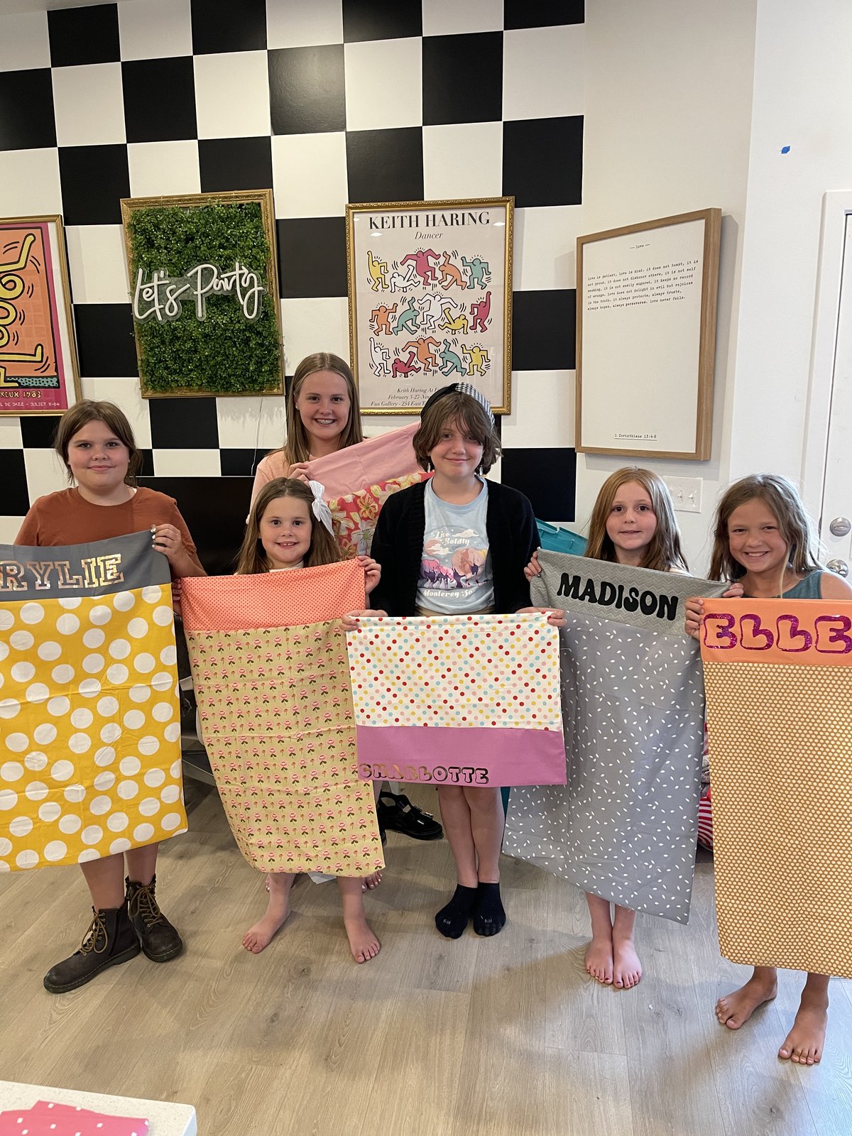 Group holding up personalized pillowcases